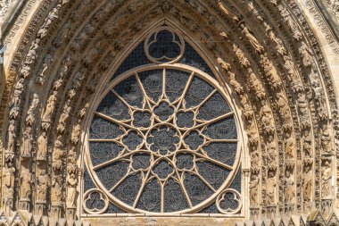 Central portal and rose window of the Reims Cathedral in Reims, the most populous city in the French department of Marne clipart