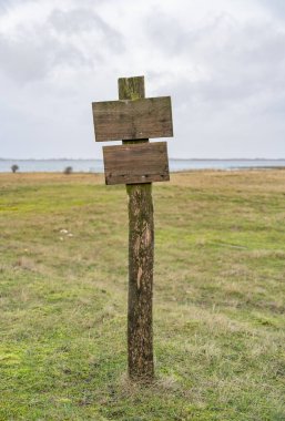 Wooden post near Olpenitz, a part of the town Kappeln in Schleswig-Holstein, Germany, at the mouth of the Schlei firth to the Baltic Sea. clipart