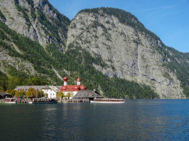 St. Bartholomews Church at a lake named Koenigssee located in the Berchtesgadener Land in Bavaria (Germany) at summer time clipart