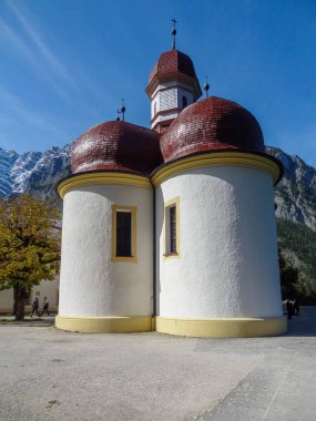 St. Bartholomews Church at a lake named Koenigssee located in the Berchtesgadener Land in Bavaria (Germany) at summer time clipart