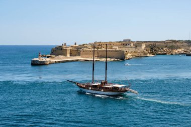 A Turkish Gulet cruising by the Ricasoli East Break - Valletta, Malta