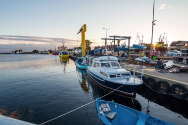Jastarnia, Poland 11 July 2021: Harbor of the tiny holiday resort town Jastarnia in the North Coast of Poland, Baltic Sea. Sunset time