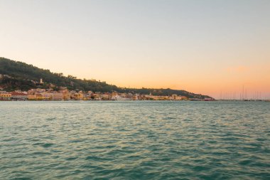 View on town hall and Saint Dionysios Church, Ionian Sea, Zakynthos island, Greece, Europe. Amazing sunset view. Zakynthos tower in the evening lights. The main harbor of the city.