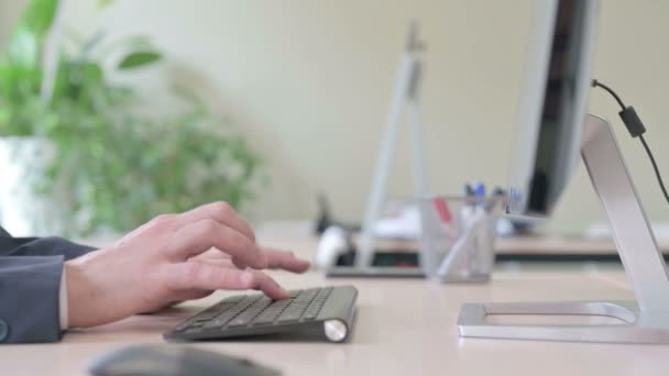 若いビジネスマンのサイドビューデスクトップキーボードを入力する — ストック動画