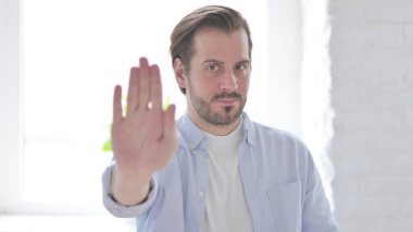 Portrait of Rejecting Mature Man Showing Stop Sign