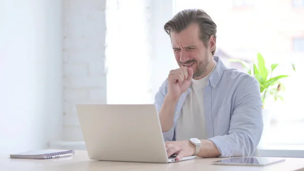 Mature Man Coughing While Using Laptop — Stockfoto