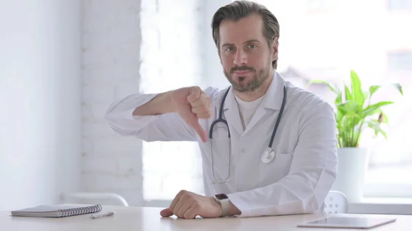 Male Doctor Showing Thumbs While Sitting Clinic — Foto Stock