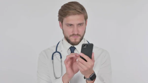 Young Adult Doctor Browsing Smartphone White Background — Zdjęcie stockowe