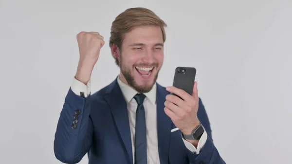 Young Adult Businessman Celebrating Smartphone White Background — стоковое фото
