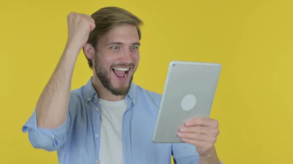Casual Jonge Man Viert Succes Tablet Gele Achtergrond — Stockfoto