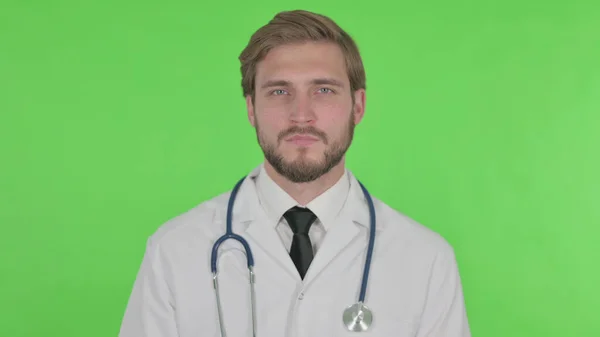 Serious Young Adult Doctor Green Background — Fotografia de Stock