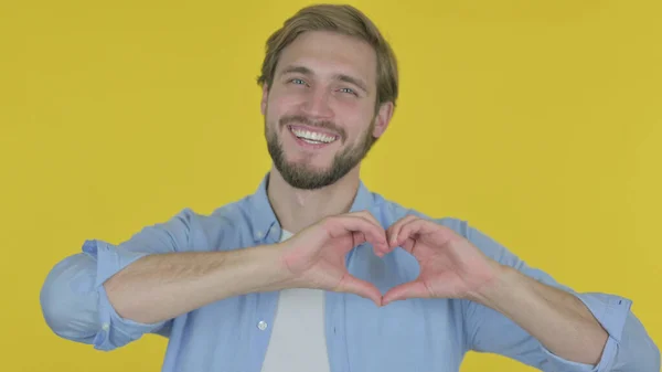 Casual Young Man Showing Heart Shape Hands Yellow Background — Stock Fotó