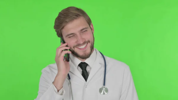 Young Adult Doctor Talking Phone Green Background — Stok fotoğraf