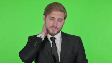 Young Adult Businessman with Neck Pain on Green Background