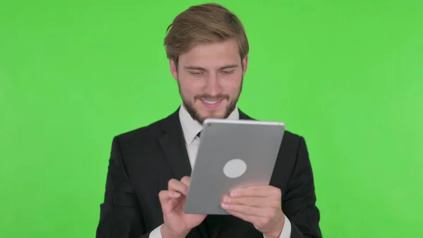 Young Adult Businessman Using Digital Tablet Green Background — Stok fotoğraf