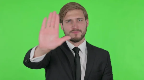 Rejecting Young Adult Businessman Arm Gesture Green Background — Stok Foto