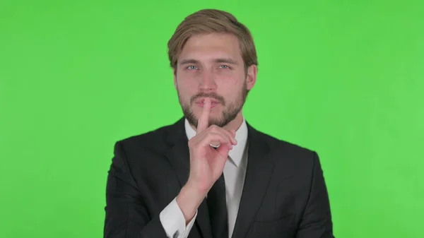 Young Adult Businessman Finger Lips Silence Green Screen — Stockfoto