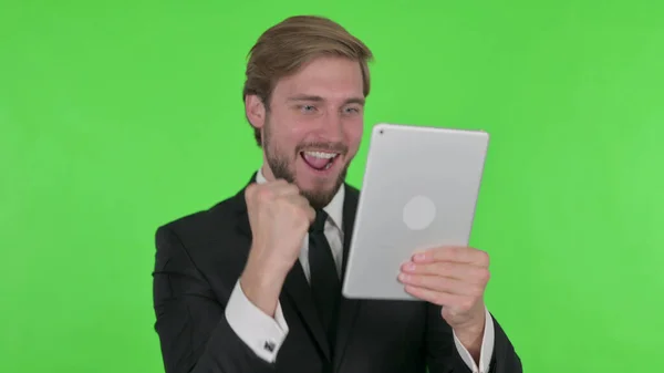 Young Adult Businessman Celebrating Success Tablet Green Background — ストック写真