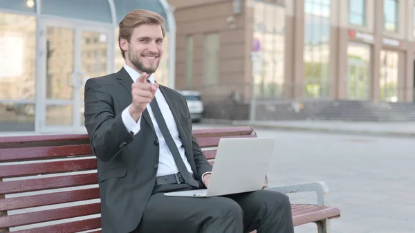 Businessman Pointing Camera While Sitting Bench Outdoor — Stok fotoğraf