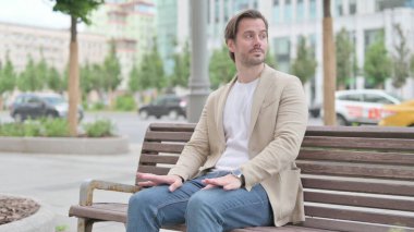 Man Coming, Sitting on Bench and Working on Laptop