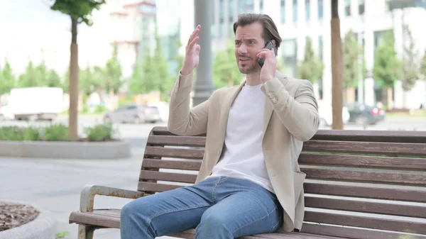 Angry Man Talking Phone While Sitting Bench — Stockfoto