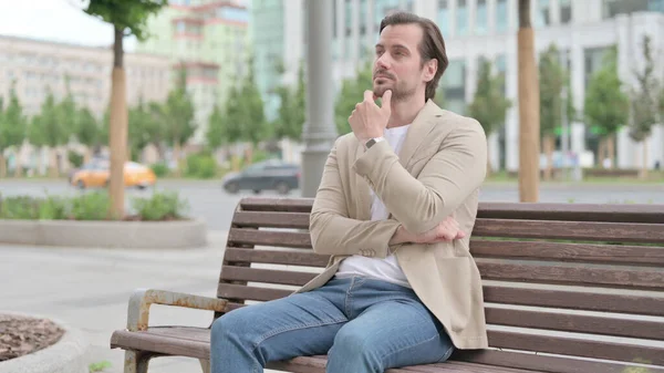 Pensive Man Thinking While Sitting Bench — Stockfoto