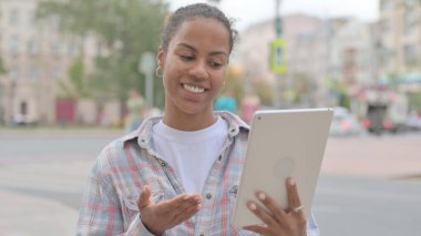 Video Call on Tablet by Young African Woman Outdoor