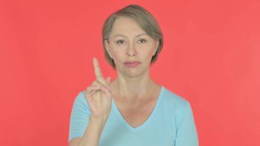 Rejecting Senior Old Woman in Denial on Red Background