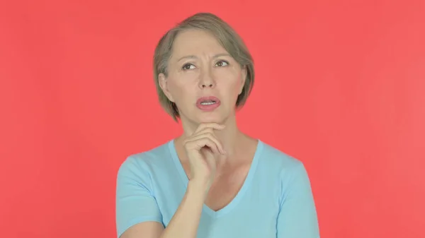 Pensive Senior Old Woman Thinking Getting Idea Red Background — 图库照片