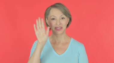 Senior Old Woman Talking on Online Video Call on Red Background