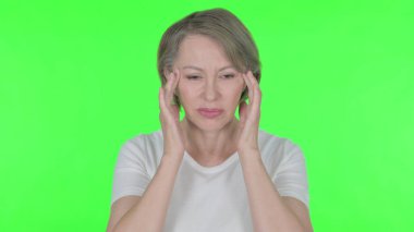 Senior Old Woman with Headache on Green Background