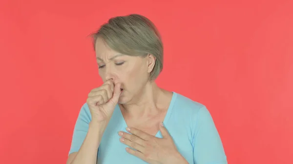 Senior Old Woman Coughing on Red Background