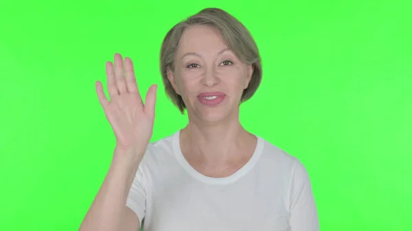 Senior Old Woman Waving Hand Say Hello Green Background — Stockfoto