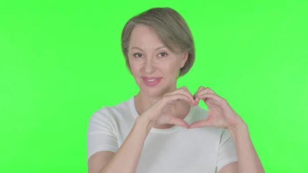 Senior Old Woman Showing Heart Shape Hands Green Background — Stock Fotó