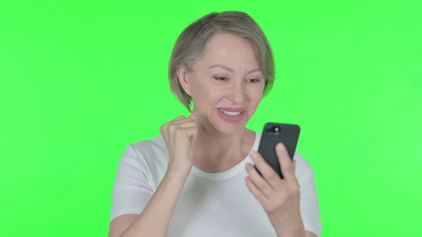 Senior Old Woman Celebrating Smartphone Green Background — Stock Fotó