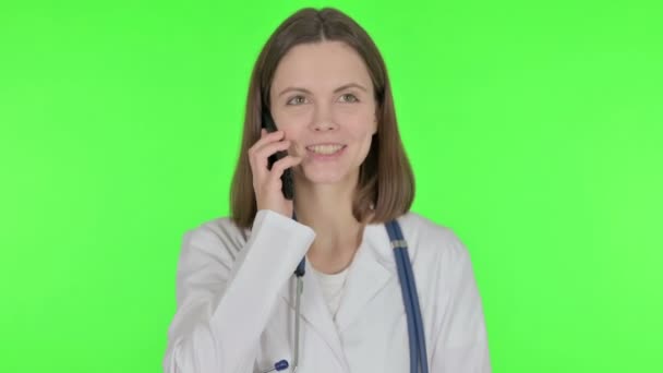 Young Doctor Talking Phone Green Background — Stock Video