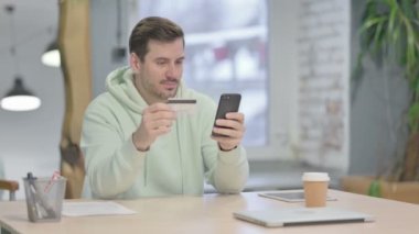 Young Adult Man making Successful Online Payment on Smartphone