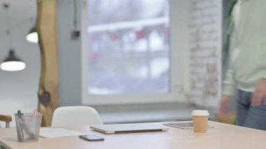 Young Adult Man Coming Back to Office and Opening Laptop