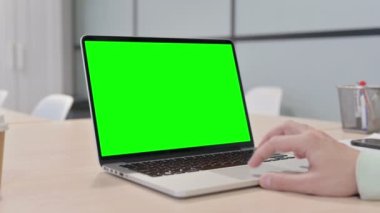 Close up of Young Adult Man Using Laptop with Green Screen