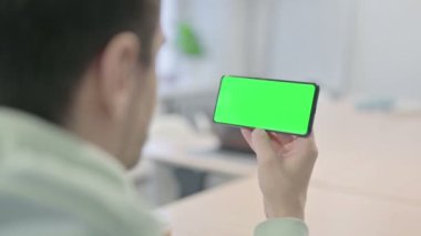Young Adult Man Watching Smartphone with Chroma Key