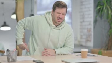 Young Adult Man with Spinal Back Pain in Office