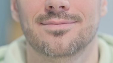 Close Up of Smiling Lips of Young Adult Man
