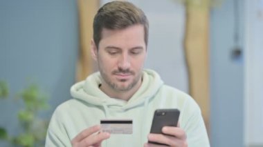 Young Adult Man Shopping Online on Smartphone