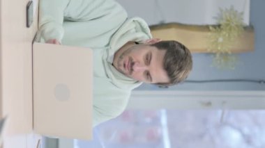 Vertical Video of Young Adult Man Leaving Office after Closing Laptop