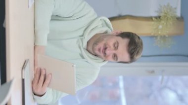 Vertical Video of Young Adult Man Cheering Success on Tablet