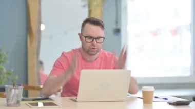 Young Adult Man Reacting to Loss While Working in Office