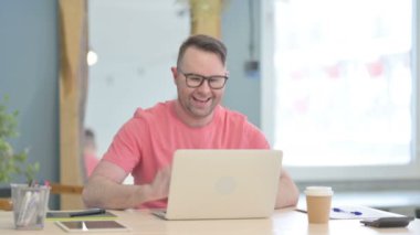 Young Adult Man Doing Online Video Chat in Office