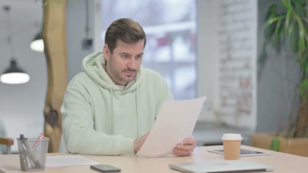 Young Adult Man Reading Documents Office Paperwork — Stock video
