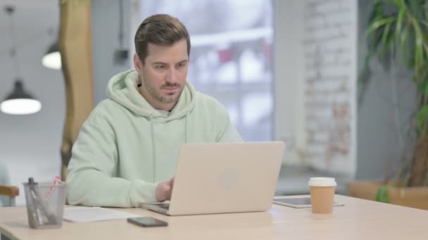 Young Adult Man Having Wrist Pain While Using Laptop — Vídeo de Stock