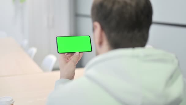 Young Adult Man Holding Horizontal Smartphone Green Screen — Wideo stockowe
